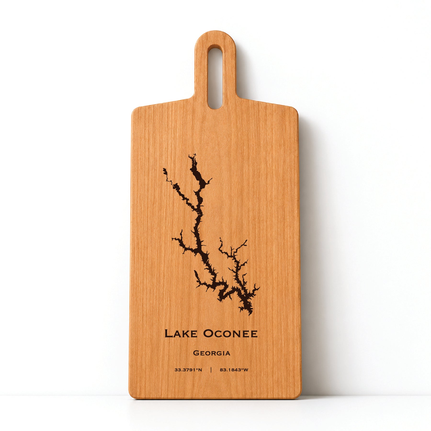 Minimal cherry wood serving board featuring engraved Lake Oconee shoreline and coordinates