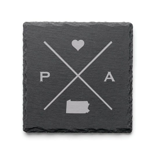 Engraved Pennsylvania slate coaster featuring a minimalist crossed-line design with heart detail and Pennsylvania silhouette on a clean light background.