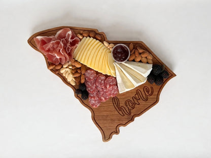 South Carolina shaped wooden serving board styled with charcuterie including cheese, meats, nuts, and fruit