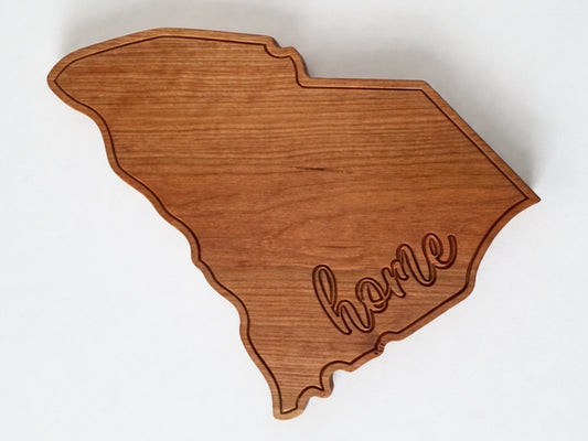 South Carolina shaped hardwood serving board with engraved home detail on white background