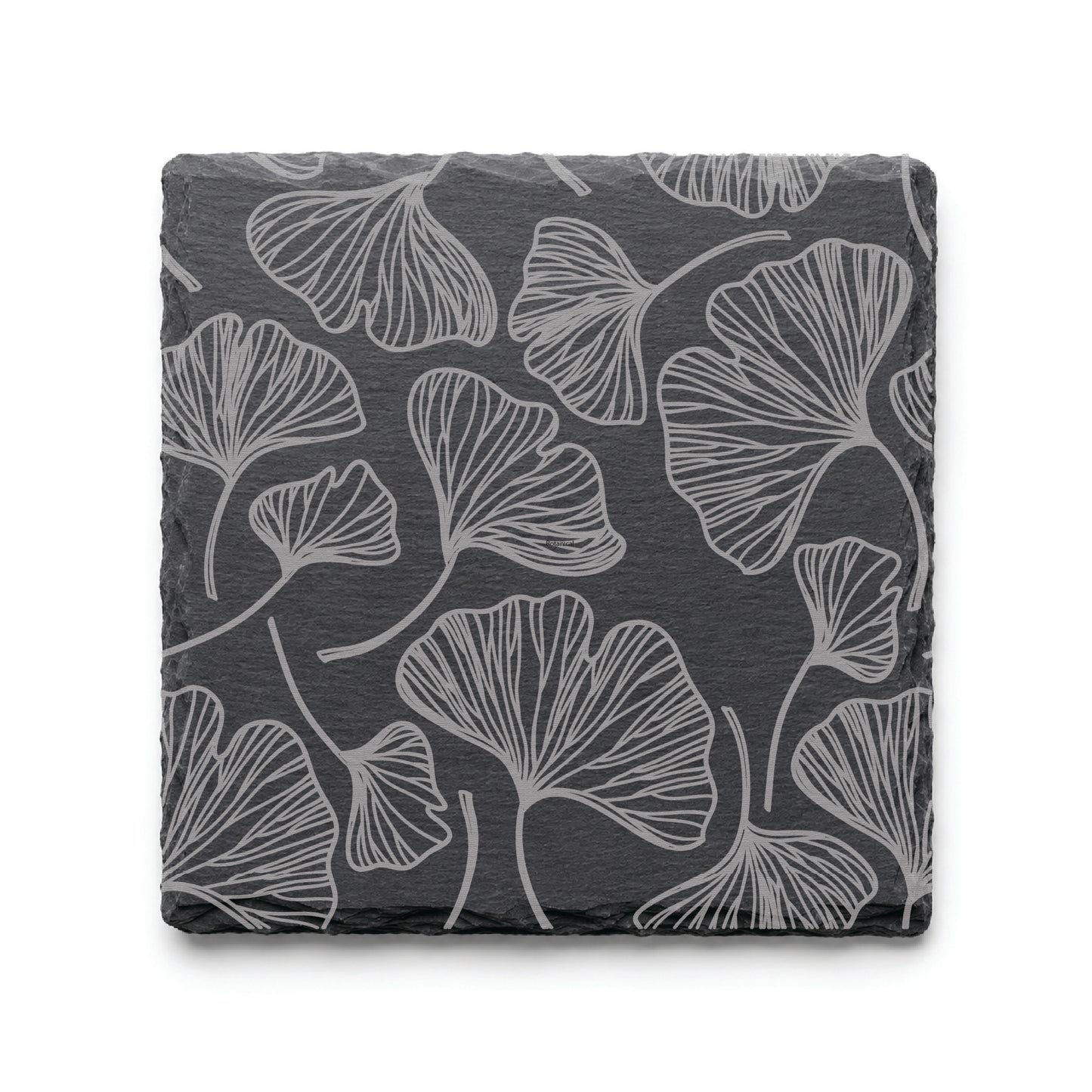 Botanical gingko leaf slate coaster with engraved leaf pattern on natural black slate background.