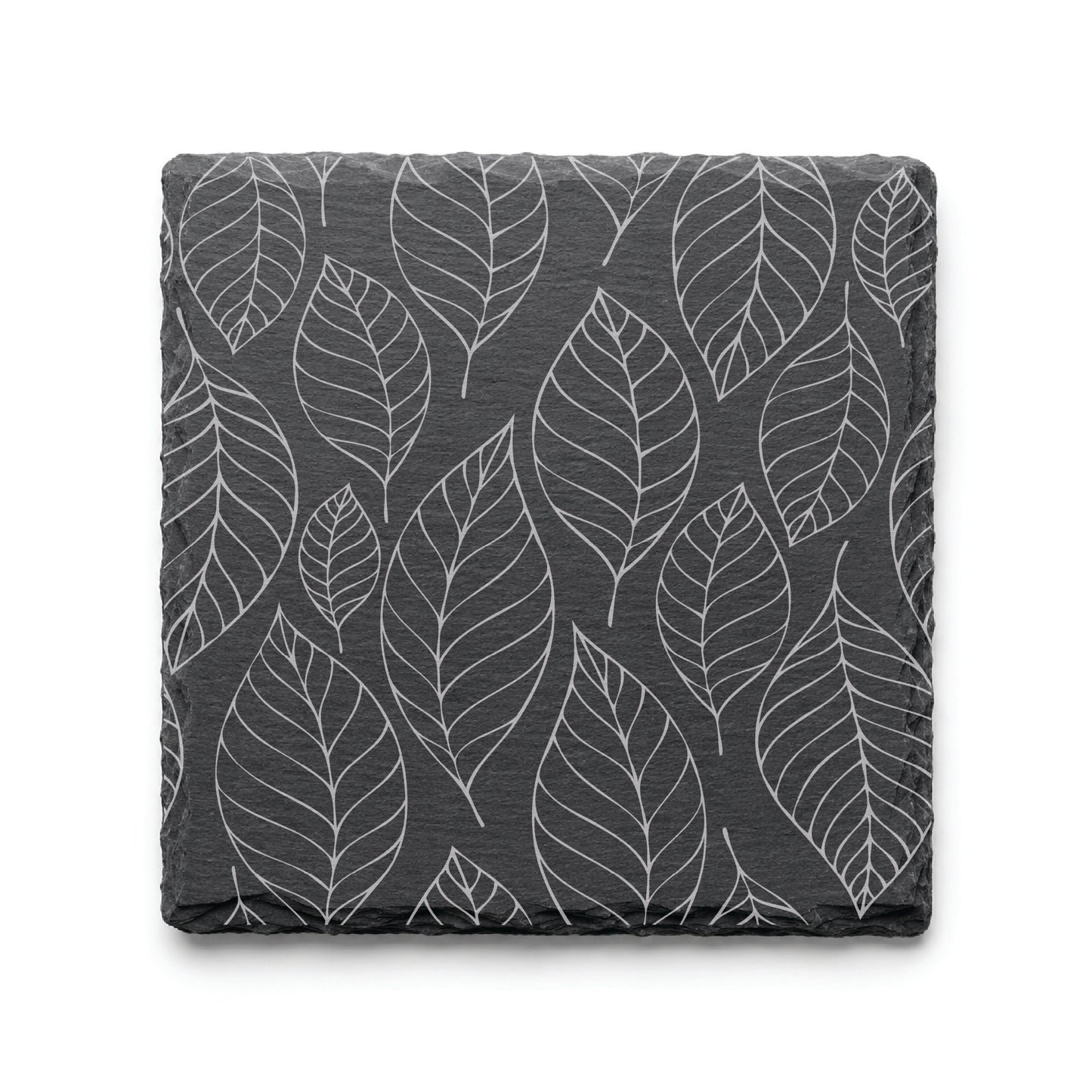 Slate coaster with engraved falling leaves pattern, showcasing detailed botanical leaf artwork on natural black slate.