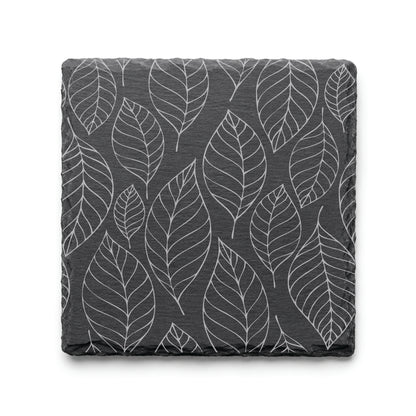 Slate coaster with engraved falling leaves pattern, showcasing detailed botanical leaf artwork on natural black slate.