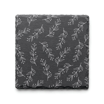 Floral Vine engraved slate coaster featuring a delicate botanical pattern with flowing vines, leaves, and berries on natural black slate.