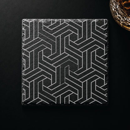 Modern Geometric engraved slate coaster displayed on a dark tabletop beside a whiskey glass, showcasing a contemporary geometric design.