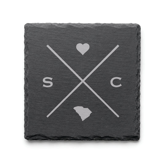 Engraved South Carolina slate coaster featuring a minimalist crossed-line design with heart detail and South Carolina silhouette on a clean light background.