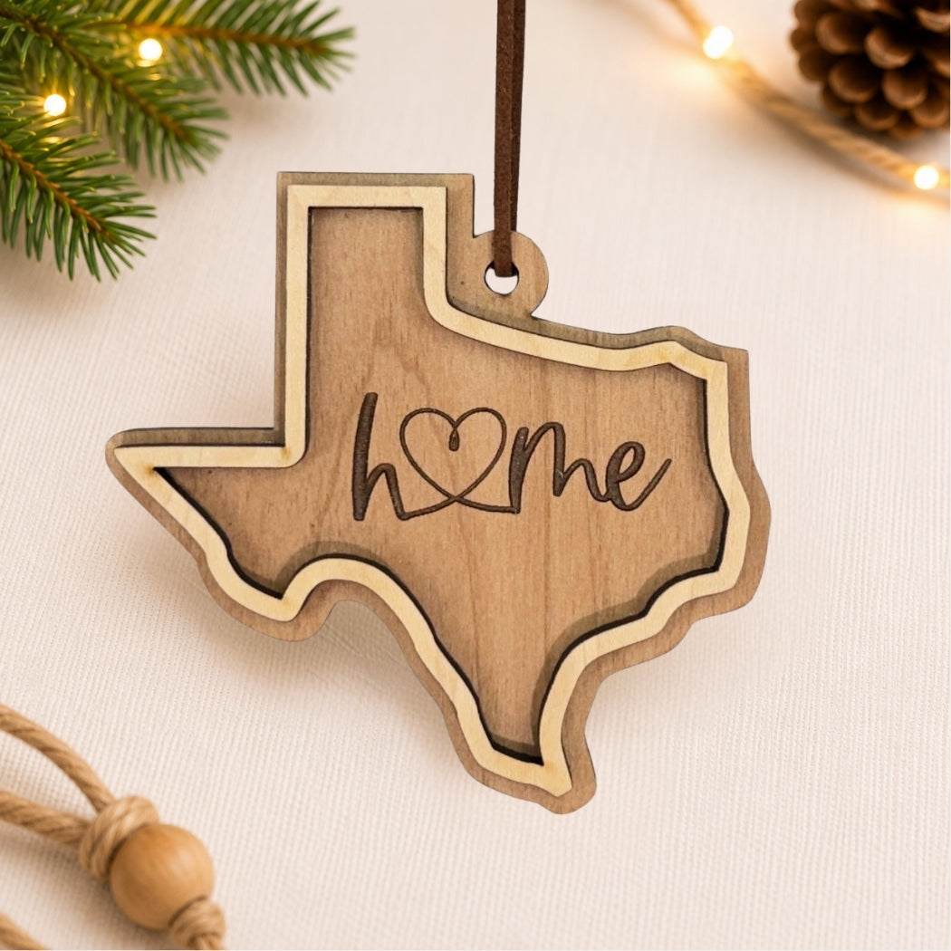 Wooden Texas-shaped ornament with 'home' engraving on a light background