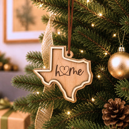 Wooden Texas-shaped ornament with 'home' text hanging on a decorated Christmas tree.
