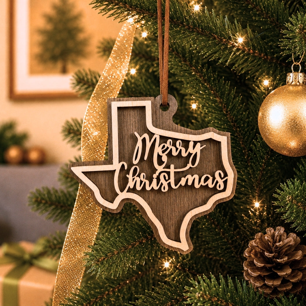 Wooden 'Merry Christmas' Texas-shaped ornament on a decorated Christmas tree.
