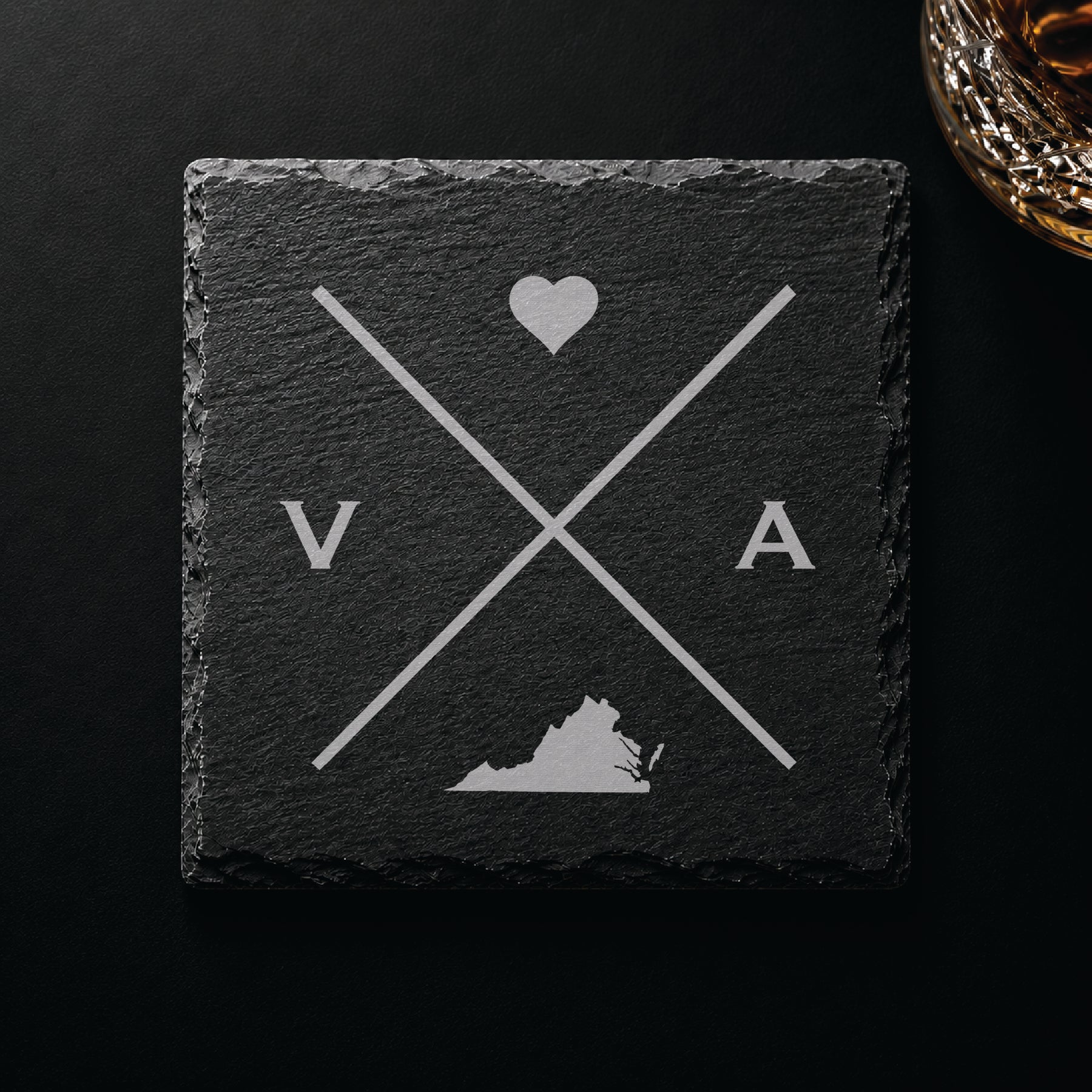 Dark slate coaster with engraved Virginia crossed-line design, heart icon, and Virginia silhouette on a dark background.