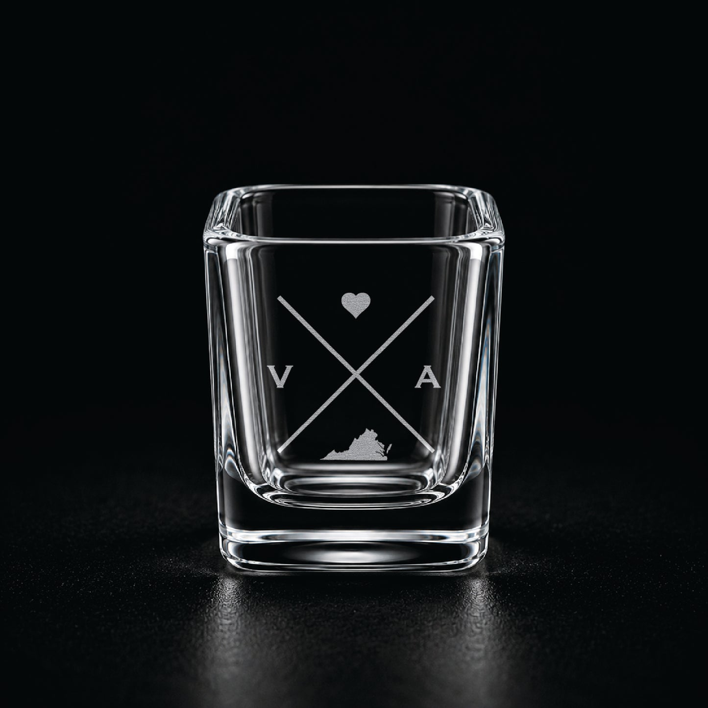 Engraved Virginia shot glass with modern crossed-line state design and frosted laser engraving on a dark background.