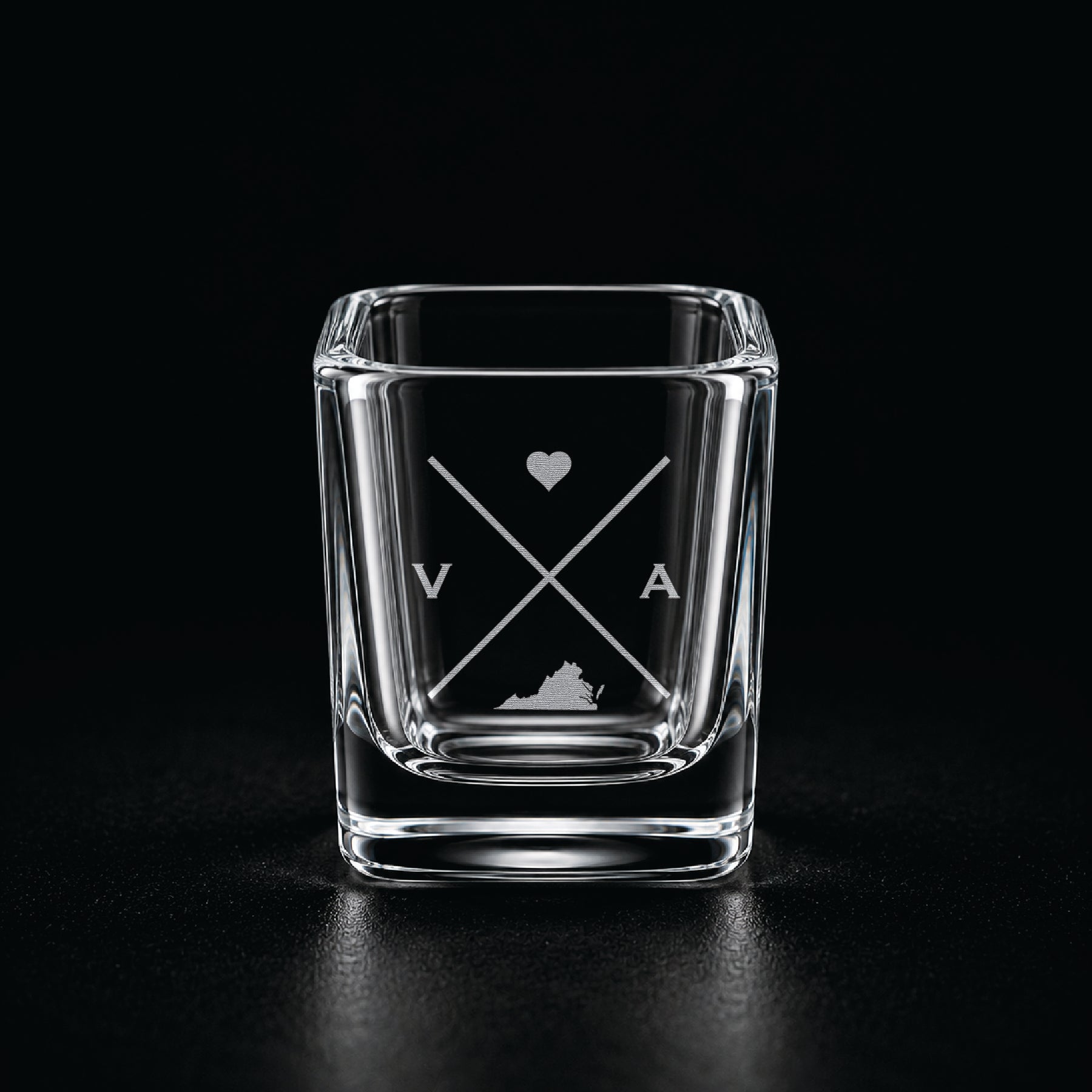 Engraved Virginia shot glass with modern crossed-line state design and frosted laser engraving on a dark background.