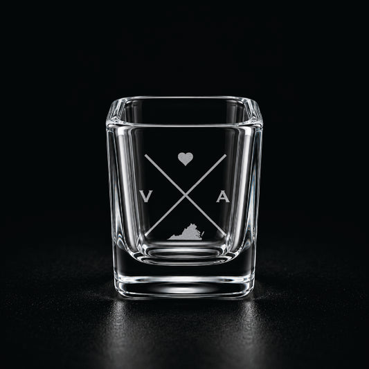 Engraved Virginia shot glass with modern crossed-line state design and frosted laser engraving on a dark background.