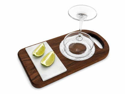 Walnut wood and marble margarita rimmer with lime wedges and margarita glass on white background.